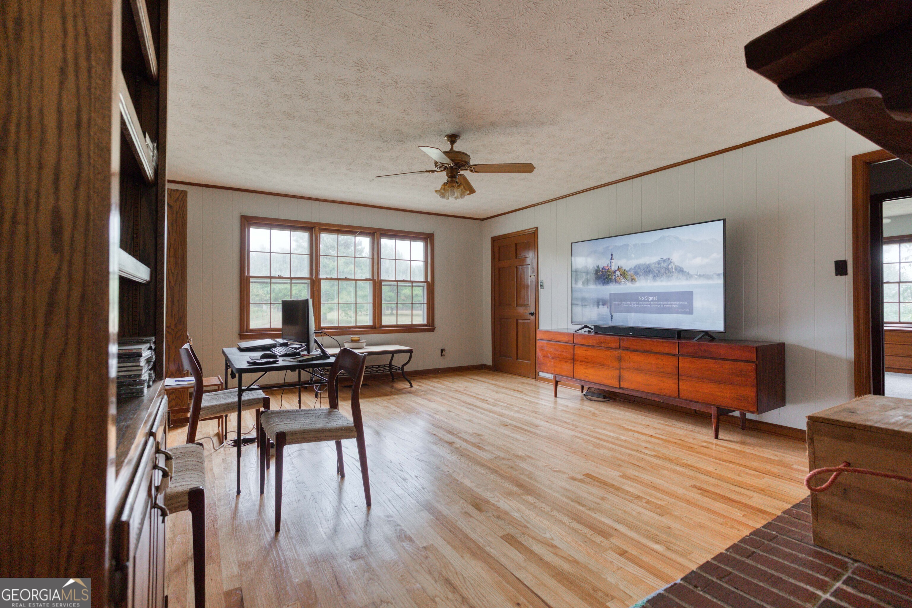 2141 Greensboro Road Madison, GA 30650 - Photo 22 of 35 a living room with furniture and a wooden floor