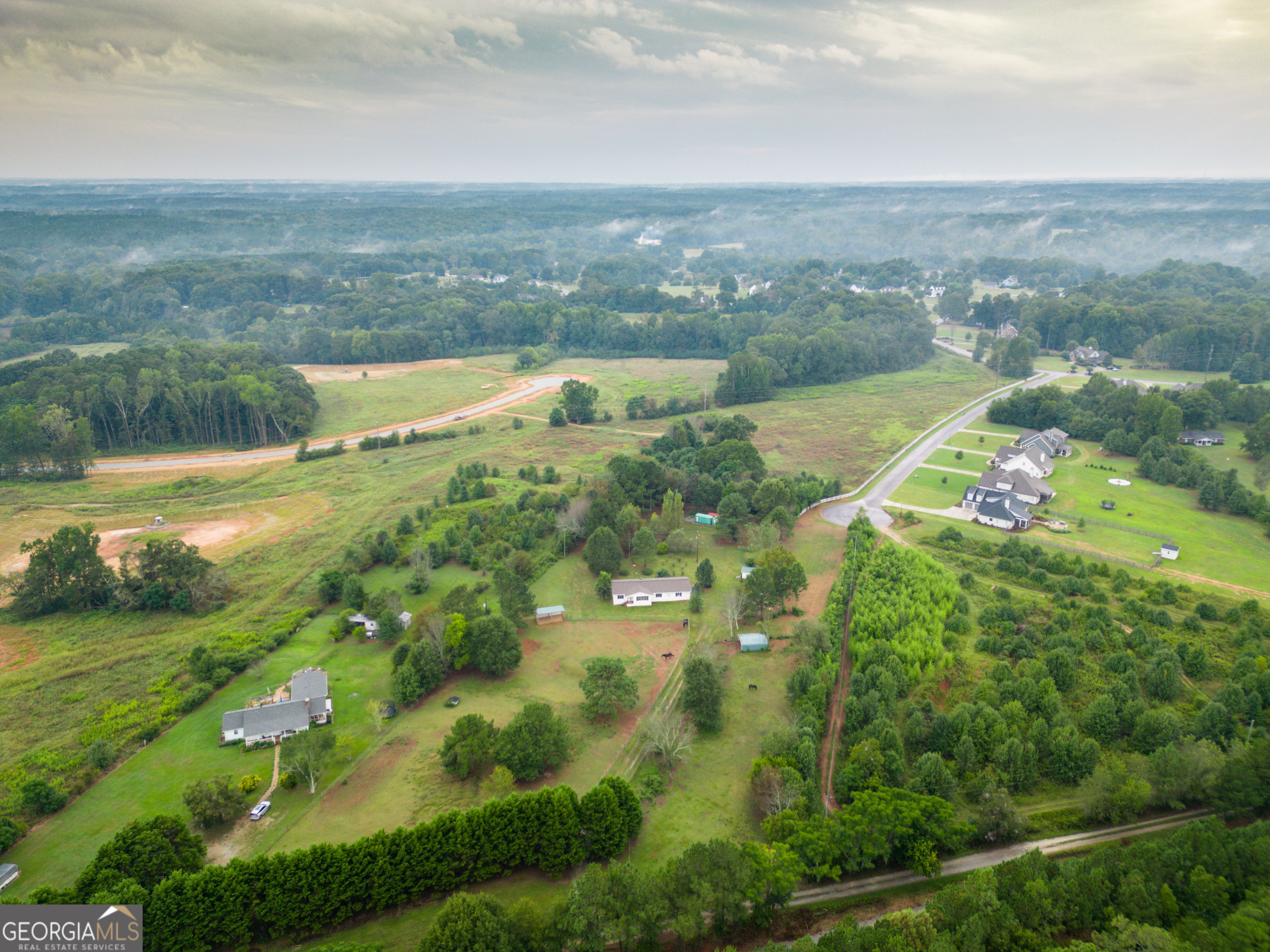 2141 Greensboro Road Madison, GA 30650 - Photo 3 of 35 an aerial view of residential houses with outdoor space and river