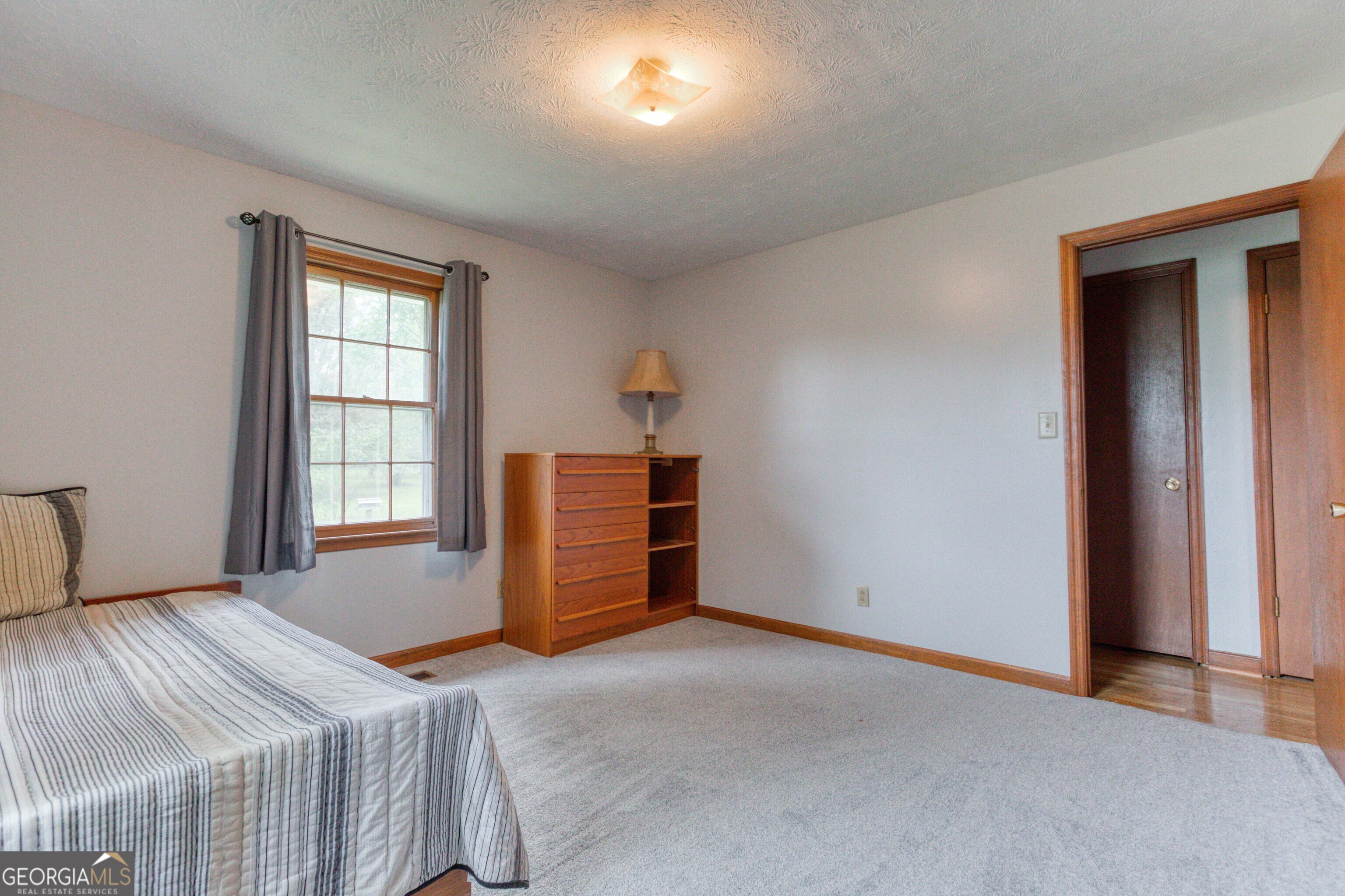 2141 Greensboro Road Madison, GA 30650 - Photo 32 of 35 a bedroom with a bed and a window