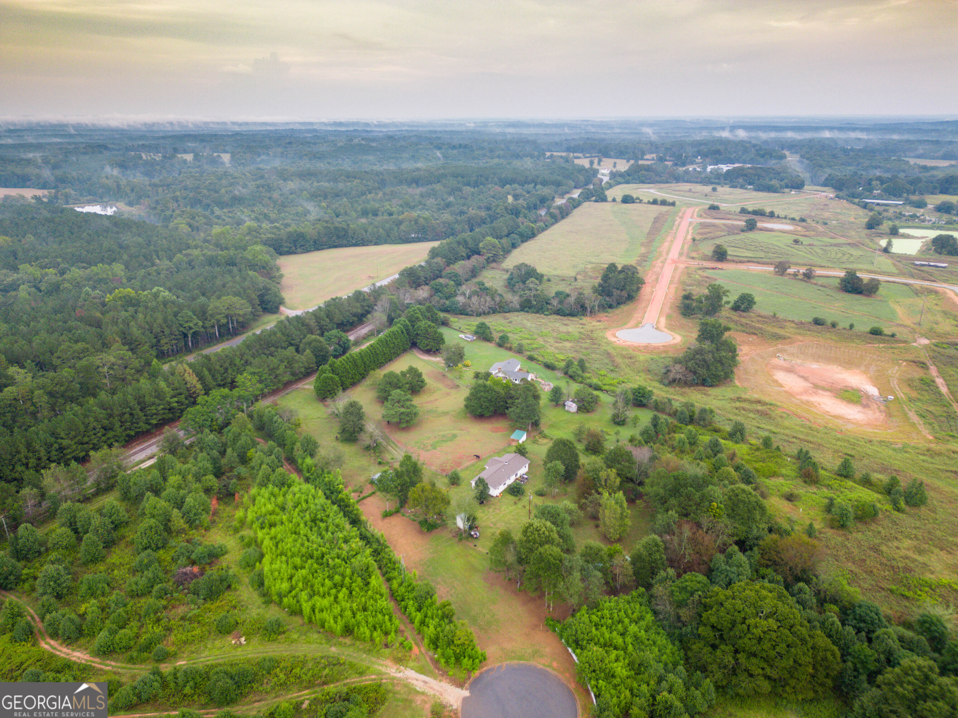 2141 Greensboro Road Madison, GA 30650 - Photo 6 of 35 an aerial view of residential houses with outdoor space