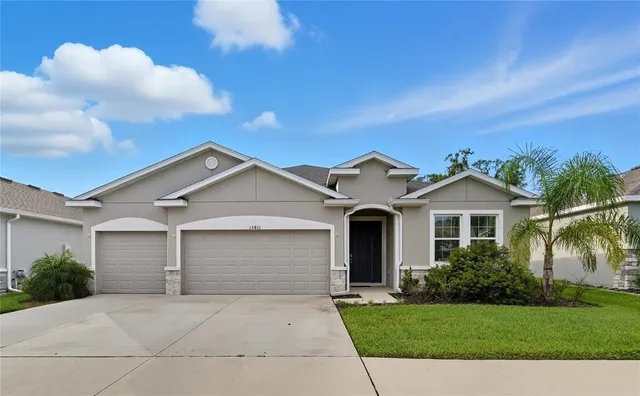 a front view of a house with a yard and garage