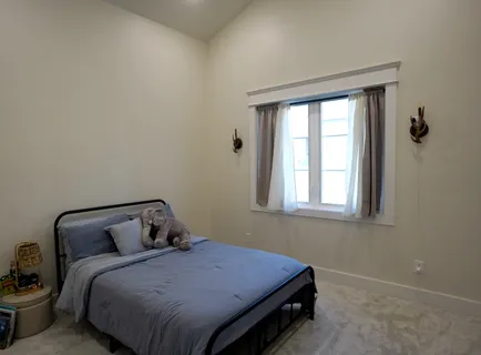 a bedroom with a bed and window