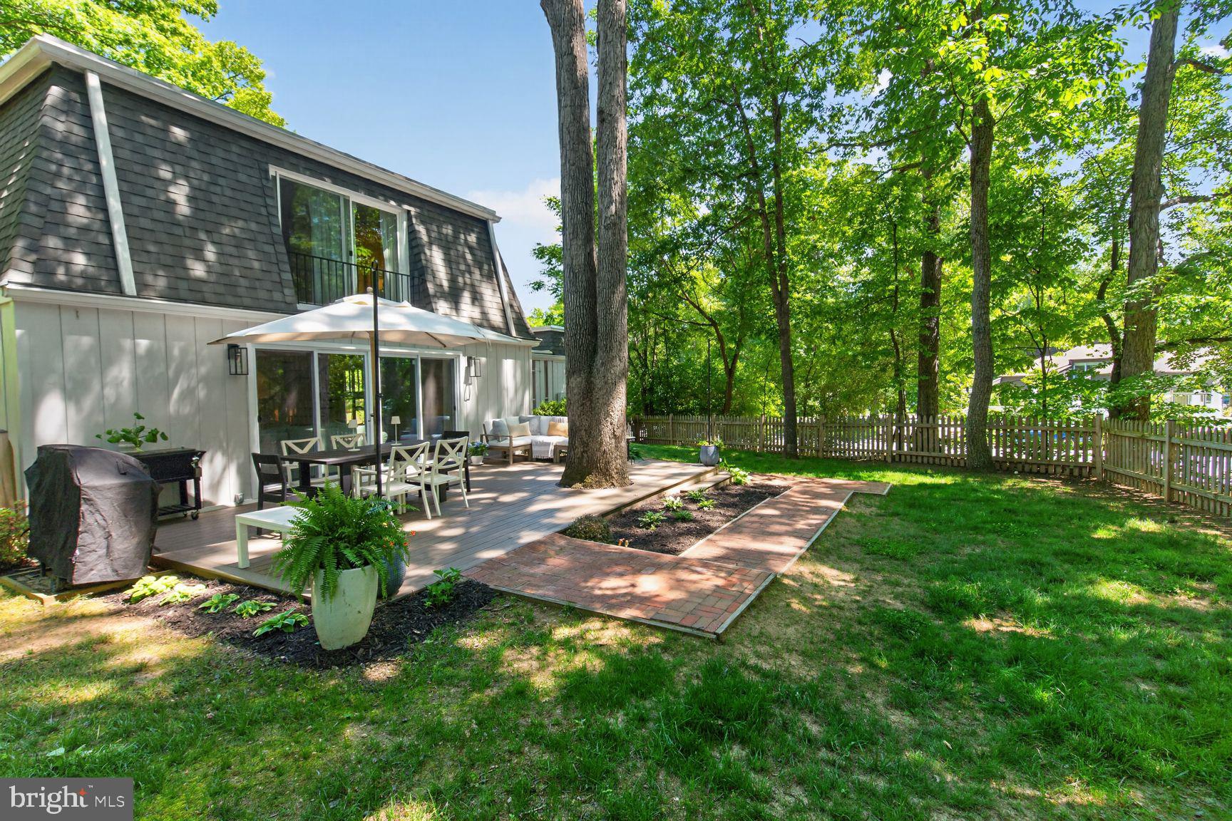 11201 Wedge Drive Reston, VA 20190 - Photo 29 of 31 a view of a patio with table and chairs potted plants and large tree