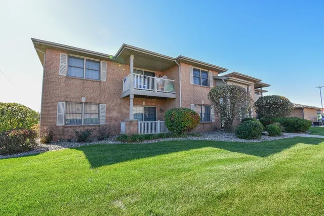 a view of a house with a yard and plants