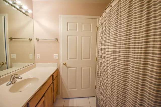 a bathroom with a sink a mirror and shower
