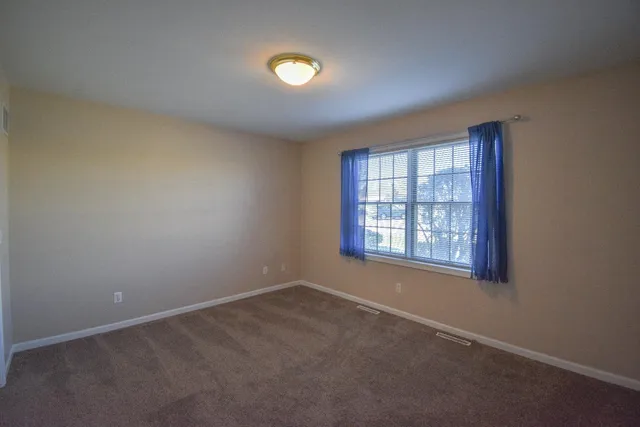 an empty room with a empty space and windows