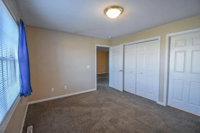 a view of an empty room and a window