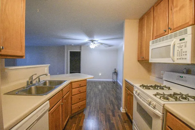 a kitchen with a sink stove and cabinets