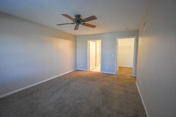 a view of a livingroom with a ceiling fan and window