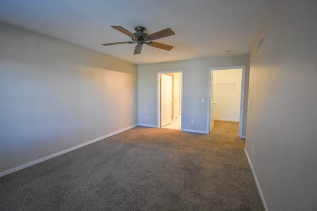 a view of a livingroom with a ceiling fan and window