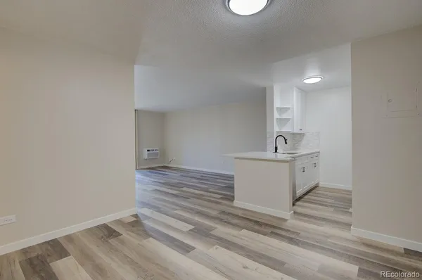 a view of a room with wooden floor and sink