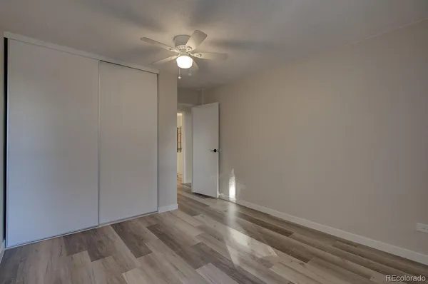 a view of an empty room with wooden floor