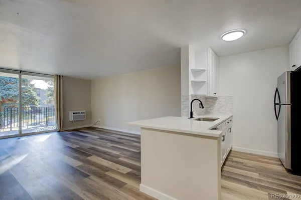 a kitchen with a sink and a refrigerator