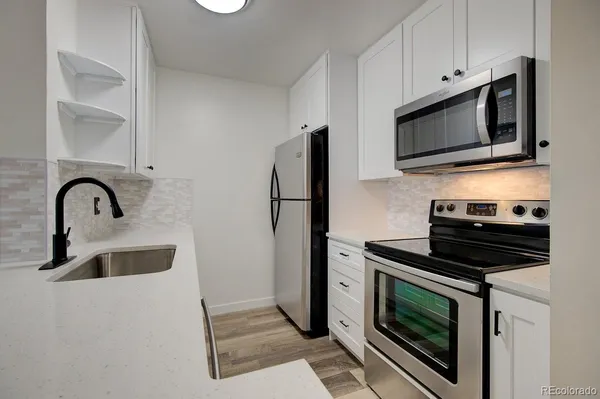 a kitchen with a stove microwave and refrigerator