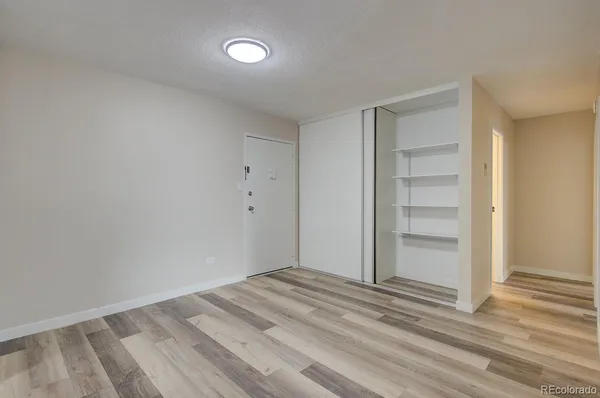 a view of wooden floor and windows in a room