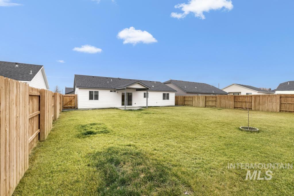 1113 Meadow Lake Loop Buhl, ID 83316 - Photo 8 of 27 Back of house with a patio and a fenced backyard