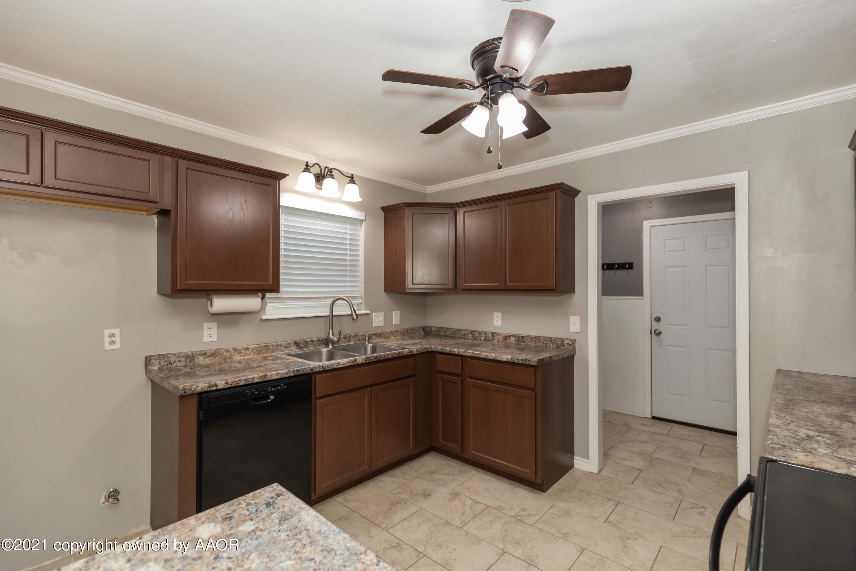 5142 McCarty Boulevard Amarillo, TX 79110 - Photo 11 of 38 a kitchen with a sink and stainless steel appliances