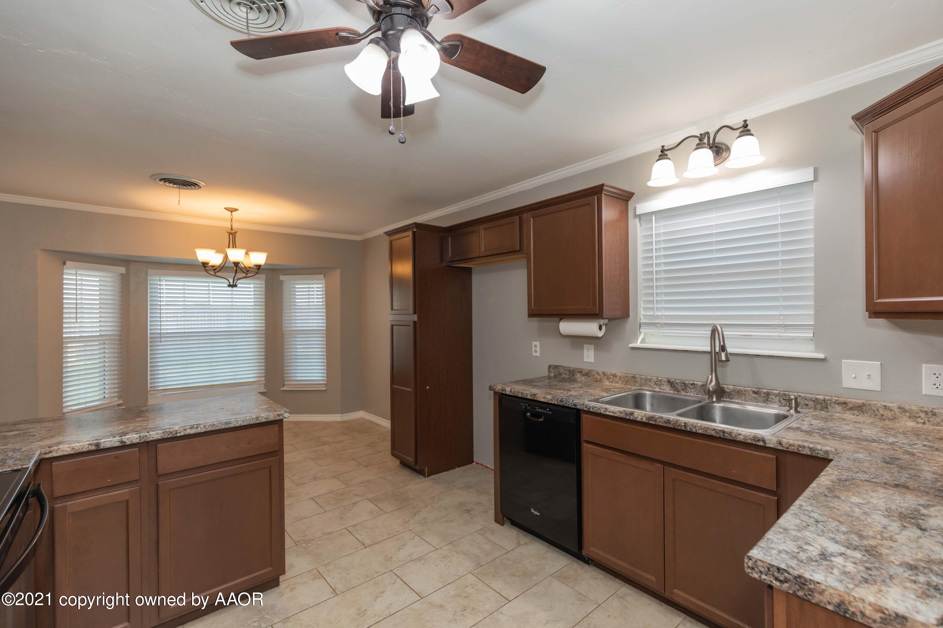5142 McCarty Boulevard Amarillo, TX 79110 - Photo 12 of 38 a bathroom with a granite countertop sink a mirror and a shower
