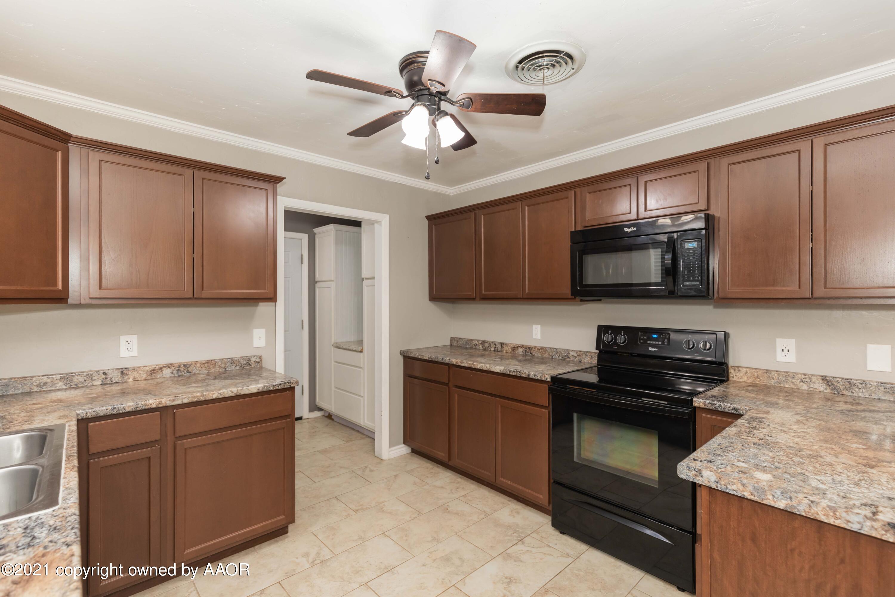 5142 McCarty Boulevard Amarillo, TX 79110 - Photo 13 of 38 a kitchen with granite countertop stainless steel appliances and wooden cabinets