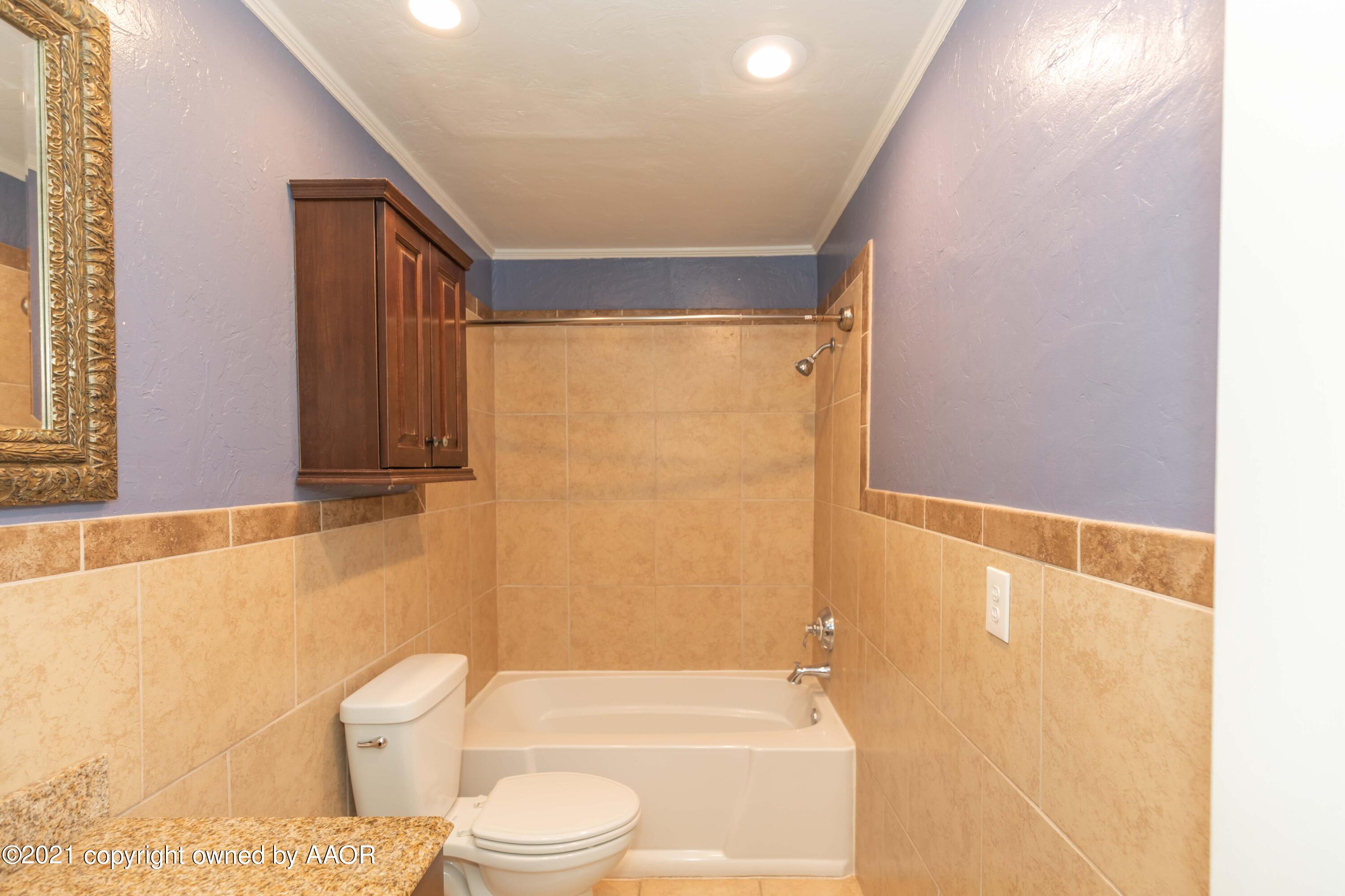 5142 McCarty Boulevard Amarillo, TX 79110 - Photo 28 of 38 a bathroom with a toilet and a shower