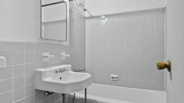 a bathroom with a sink a mirror and a bathtub