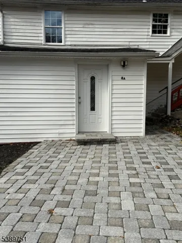 a side view of a house with a white door