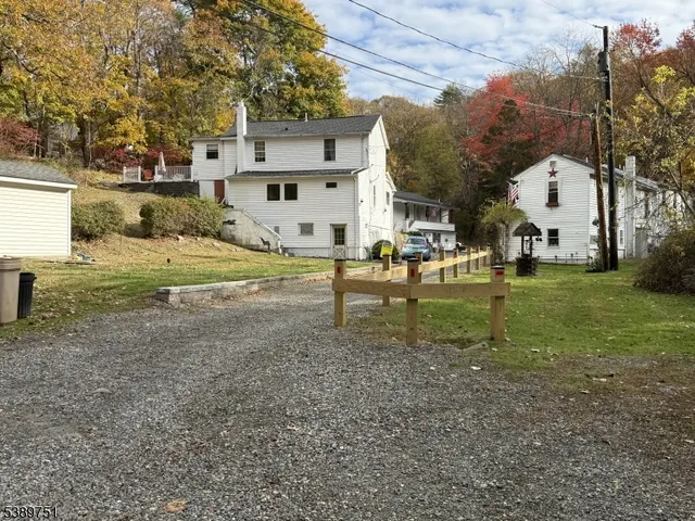 a view of a house with a yard and sitting area