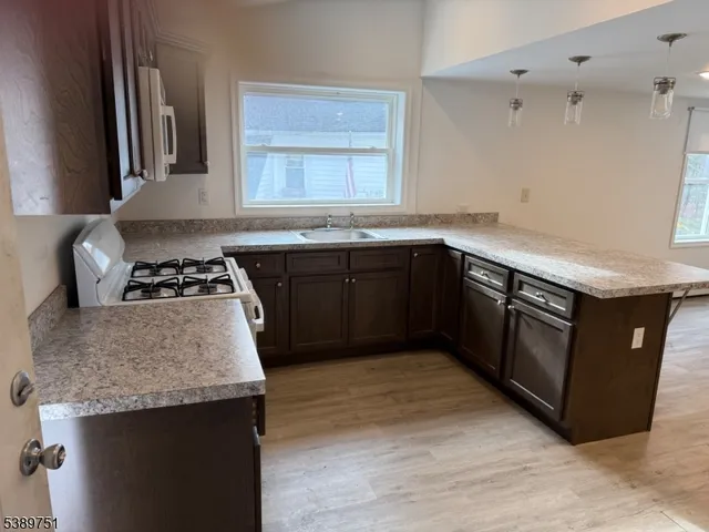 a kitchen with a sink stove and cabinets