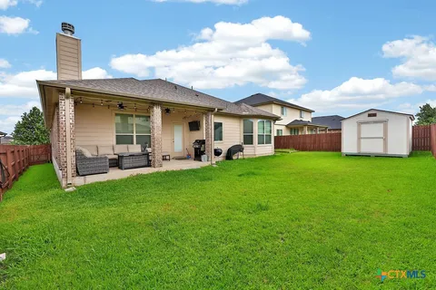 a view of a house with a backyard porch and sitting area