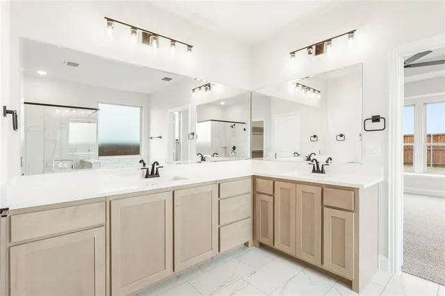 a spacious bathroom with a double vanity sink mirror and
