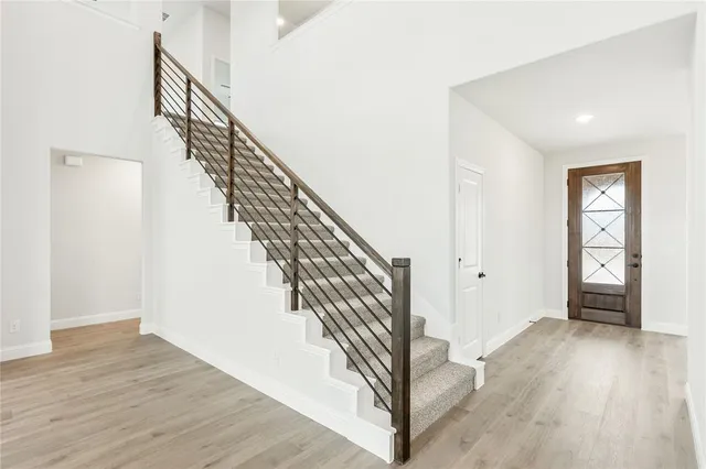 a view of entryway and hall with wooden floor