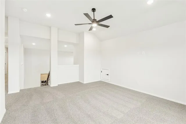 an empty room with closet and ceiling fan