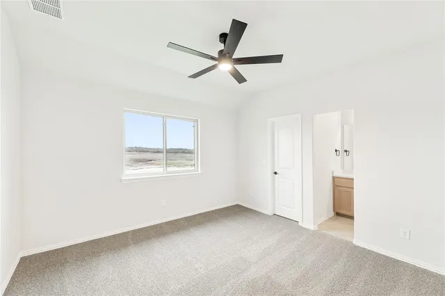 a view of a livingroom with a ceiling fan and window