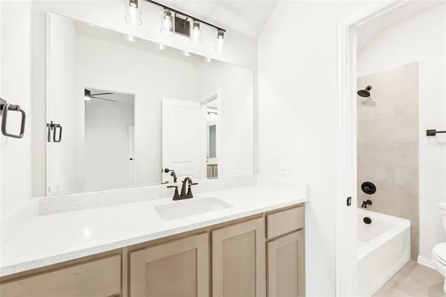 a bathroom with a sink a tub and a mirror