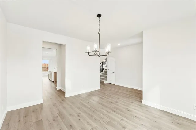 a view of a room with wooden floor ceiling fan