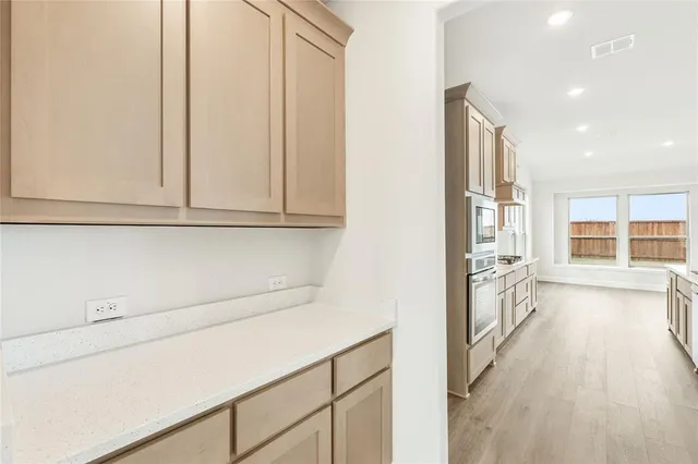a view of a kitchen with electric appliances