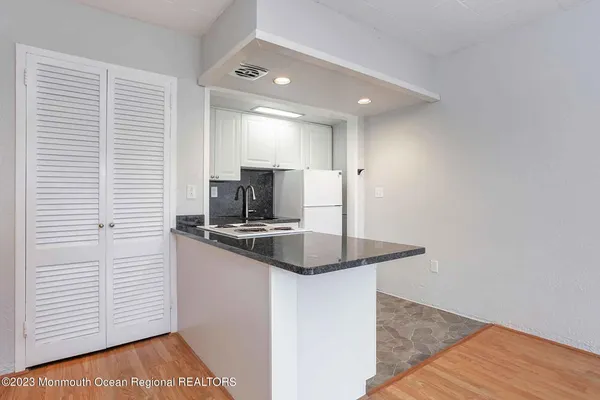 a kitchen with stainless steel appliances granite countertop a sink and a stove