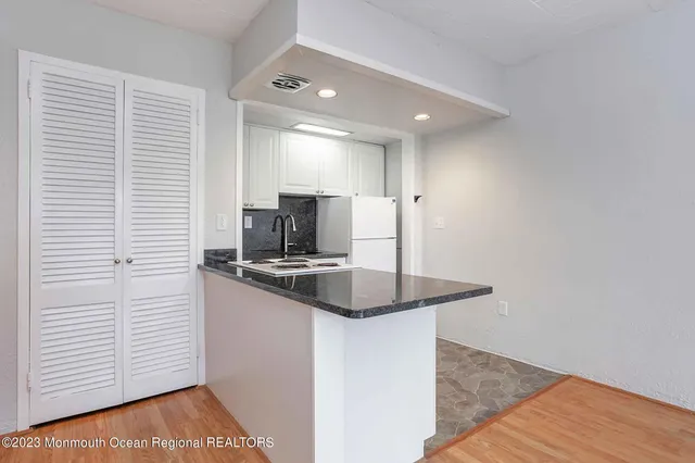 a kitchen with stainless steel appliances granite countertop a sink and a stove