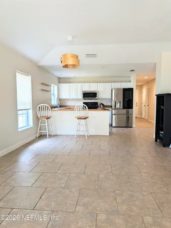 a view of kitchen with furniture and window