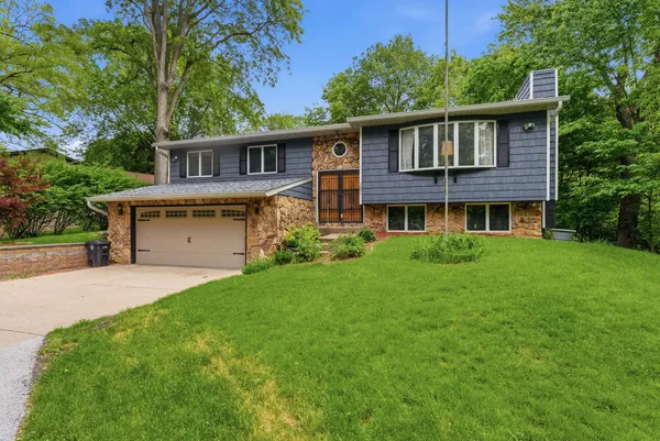 a front view of house with yard and green space