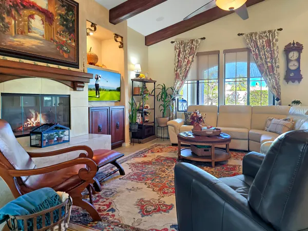 a bedroom with a bed and a flat tv screen on dresser