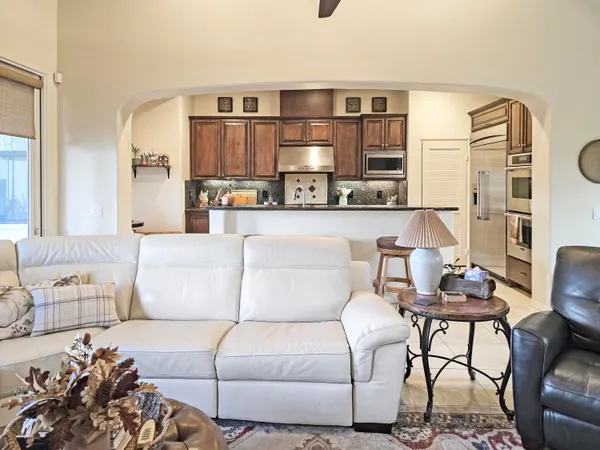 a living room with furniture and a lamp