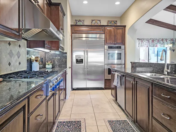 a living room with furniture a flat screen tv and next to a window