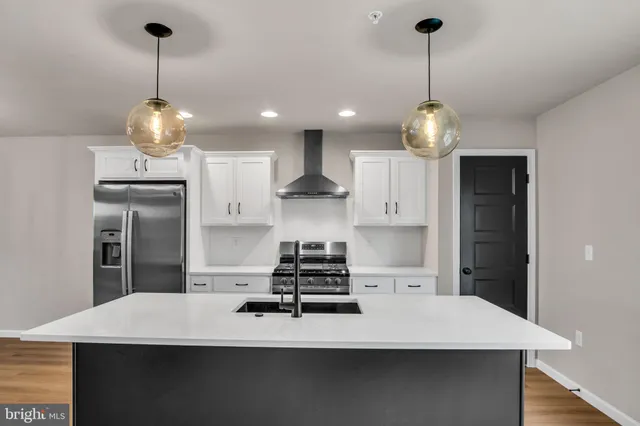 a kitchen with a table chairs and refrigerator