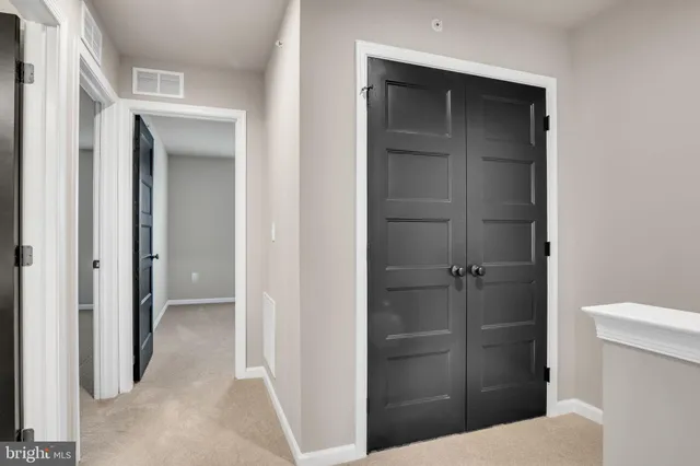 a bathroom with a walk in closet and wooden floor