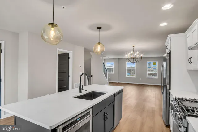 a kitchen with a table chairs and wooden floor