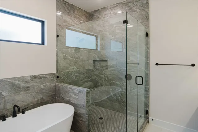 a bathroom with a toilet and a shower