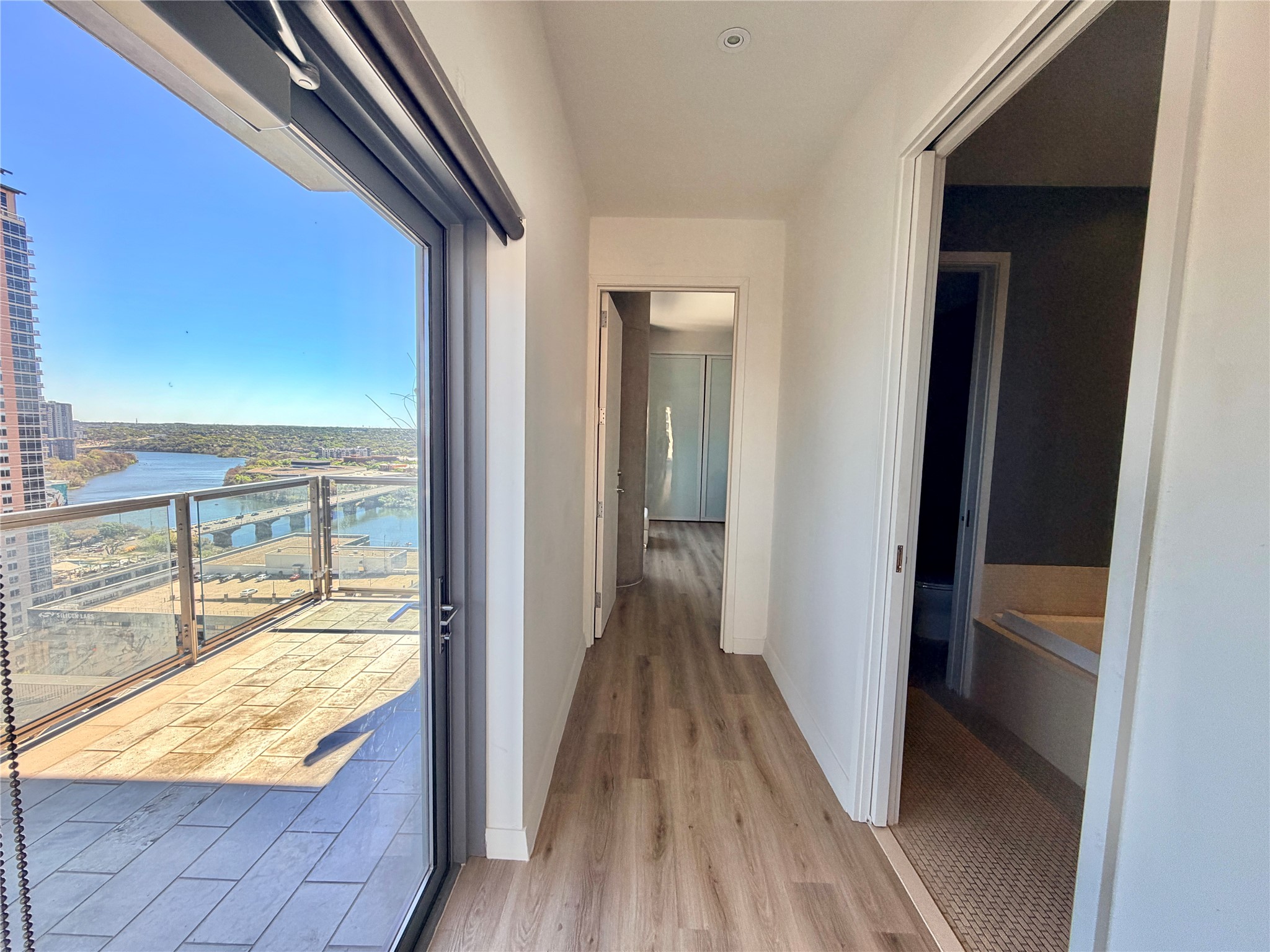 210 Lavaca Street, Unit 1912 Austin, TX 78701 - Photo 11 of 40 Corridor featuring light wood finished floors and a water view