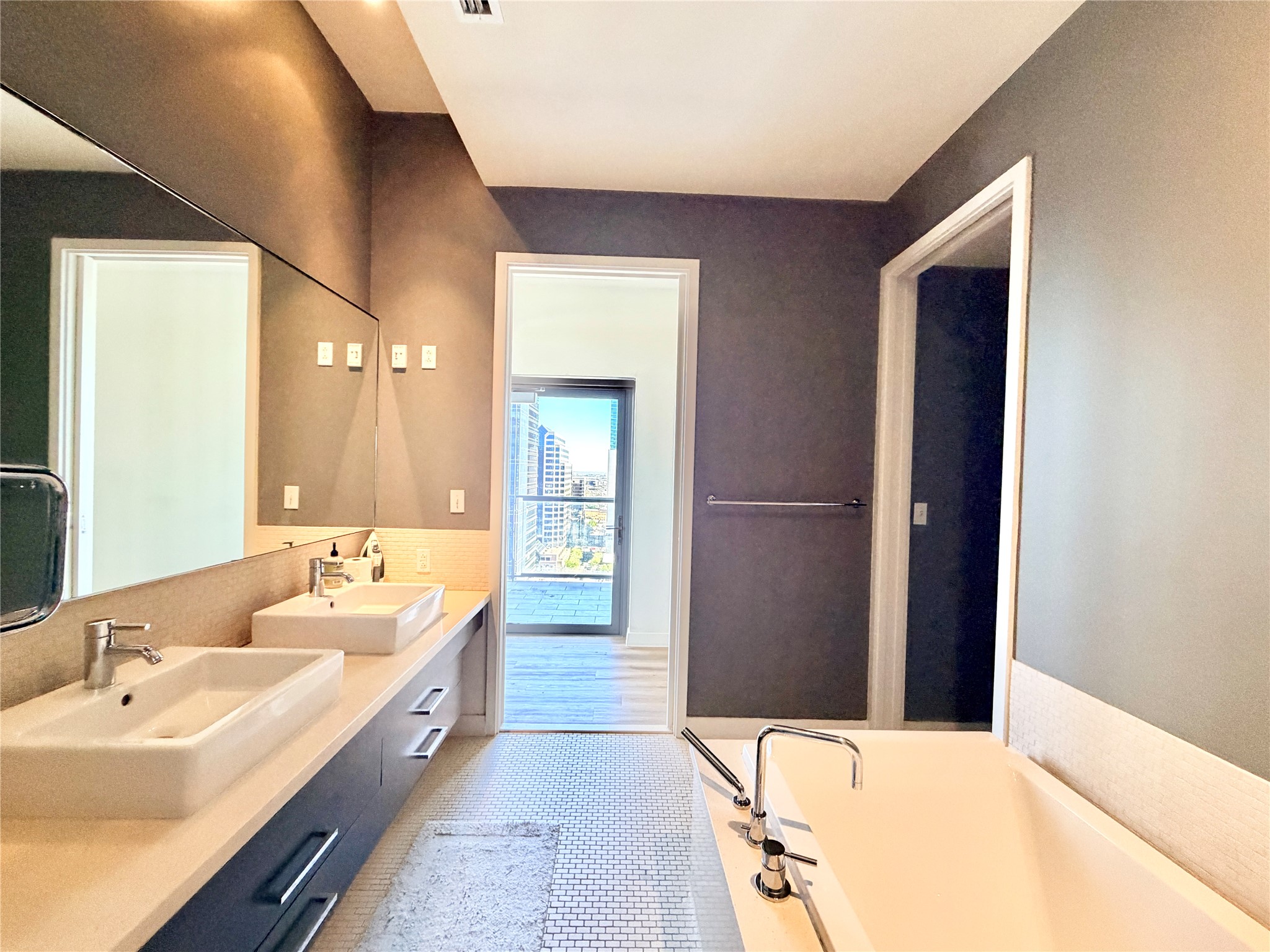 210 Lavaca Street, Unit 1912 Austin, TX 78701 - Photo 13 of 40 Full bath featuring double vanity, light tile patterned flooring, and a garden tub