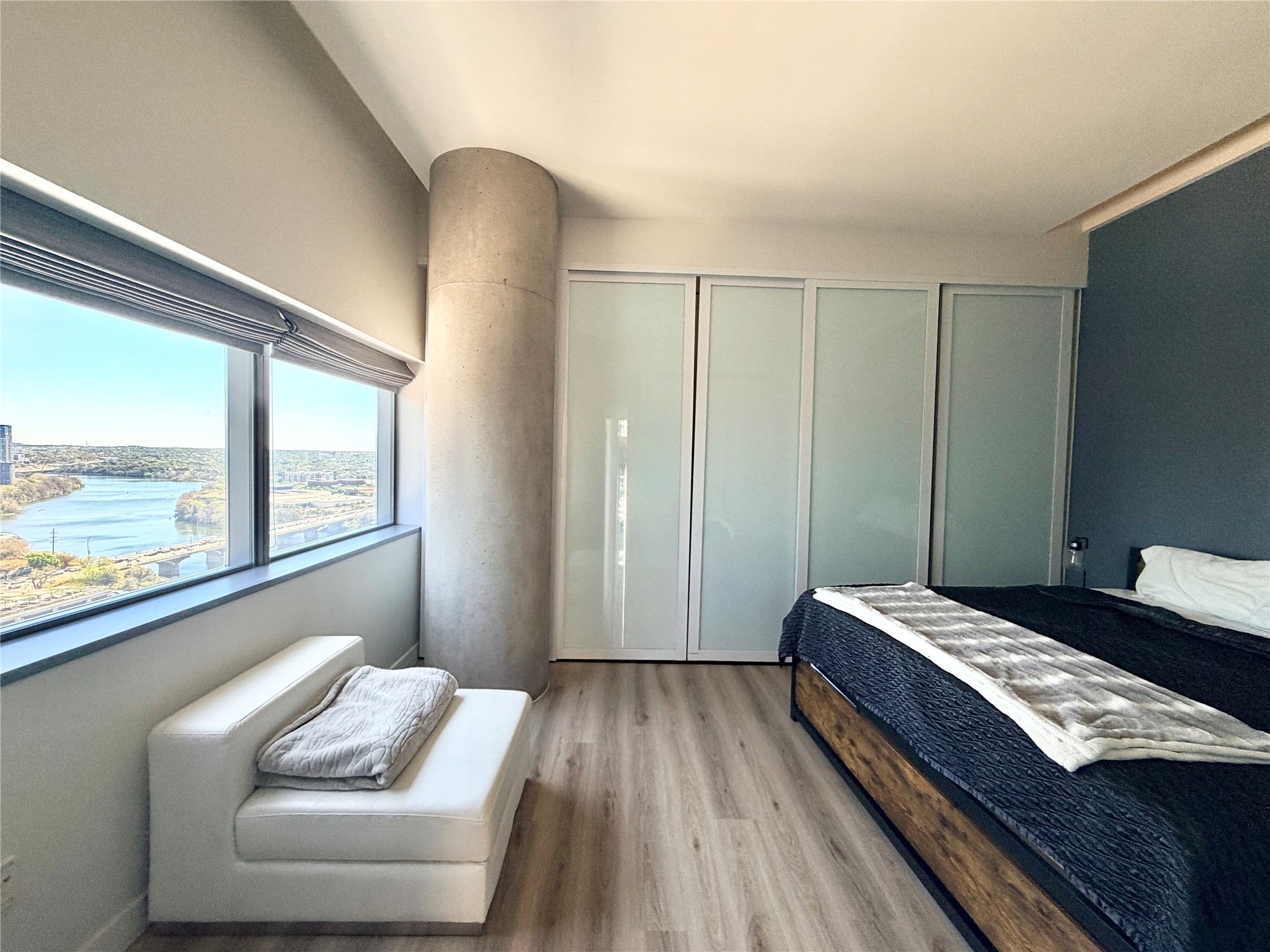 210 Lavaca Street, Unit 1912 Austin, TX 78701 - Photo 17 of 40 Bedroom with light wood finished floors and a water view